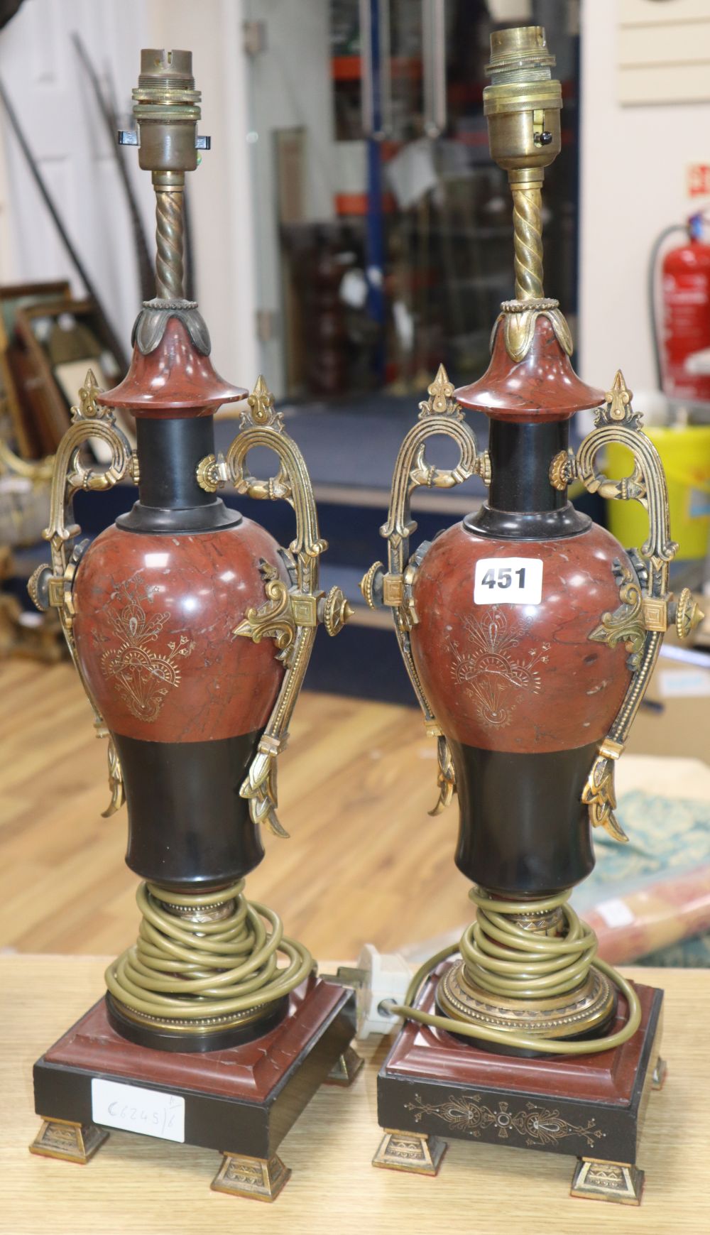 A pair of rouge marble and slate urn lamps